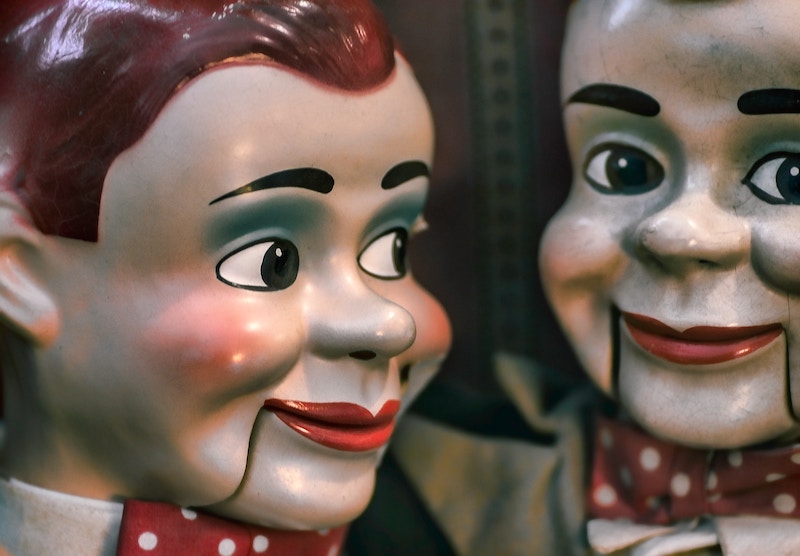 Two male dummies with eerie smiles